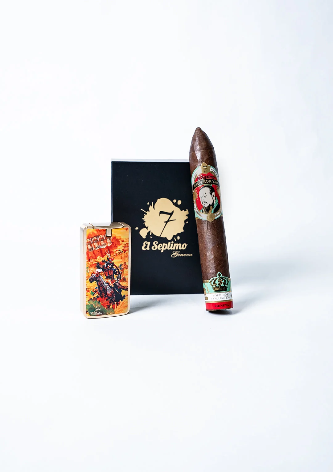 el septimo black cigar box with the words el septimo in gold letters. There is an actual cigar resting on the side of the box from the emperor yao collection and the cigar lighter from the same collection is in front of the box.
